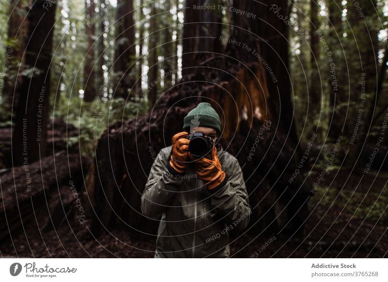Male photographer with camera in autumn forest traveler woods man wanderlust take photo photography explore male usa united states america professional hobby