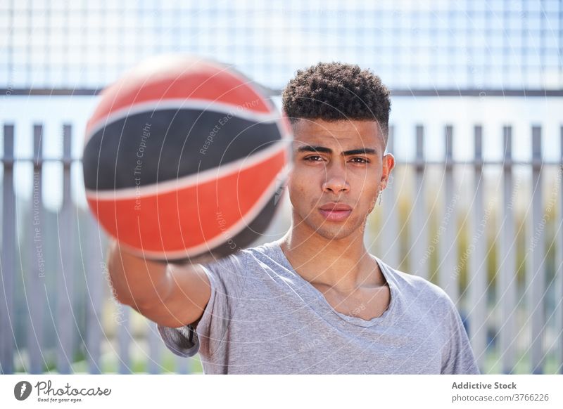 Confident black basketball player with ball confident man determine sports ground court summer sportsman male ethnic african american serious athlete sportswear