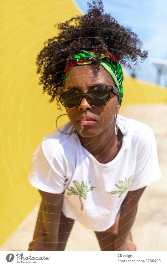 Attractive young african american woman with sunglasses and headband afro hair 1 black fashionable female hairstyle curly lady person beautiful girl beauty