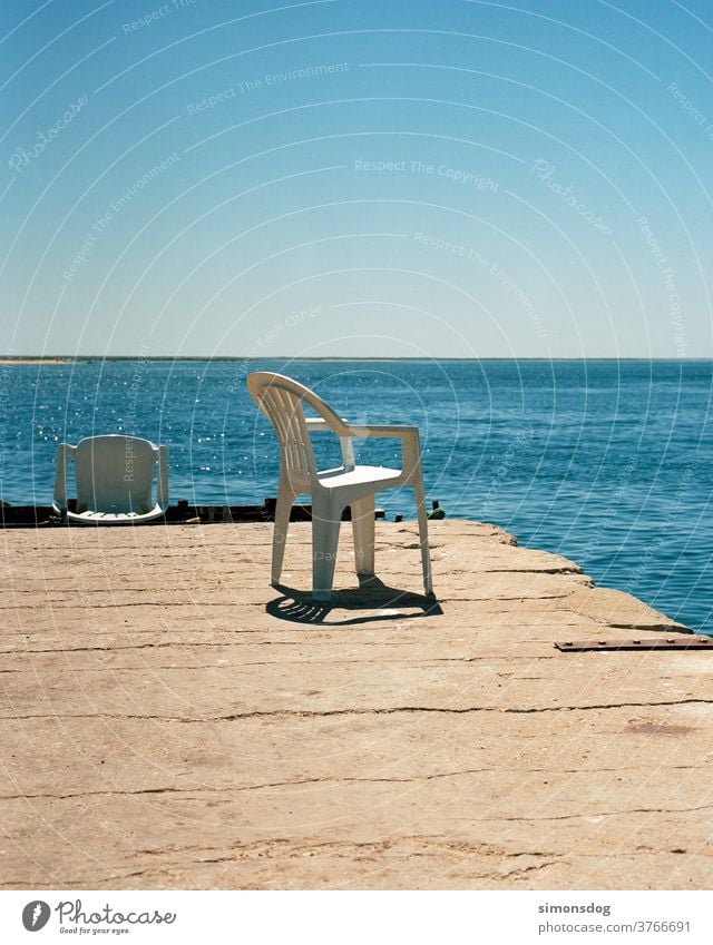 SUNPLACE sea view Chair Plastic chair Horizon Break outlook Midday sun Cloudless sky Blue Ocean