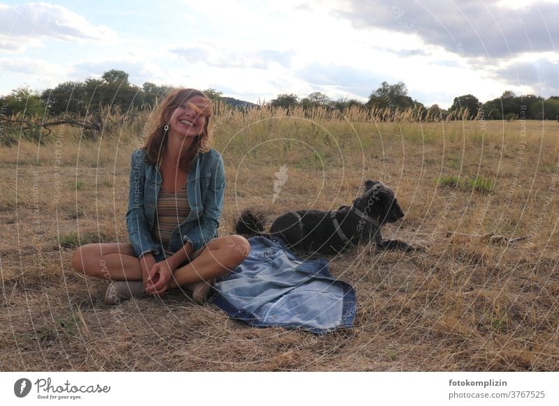 Woman with dog sits cross-legged in dry late summer meadow Sit Cross Legged time-out Dog Steppe relaxed Relaxation Breather Happy tranquillity cheerful