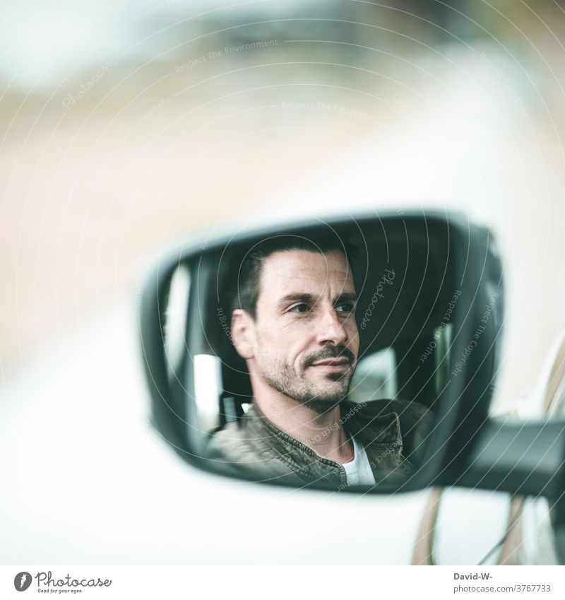 Man in side mirror of car car mirrors Side mirror Face Car driver Driving Mirror image left Calm cheerful Transport