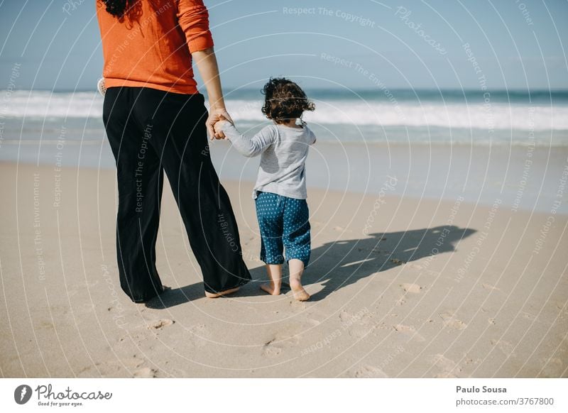 Mother and daughter looking at sea motherhood Child Daughter Beach Sandy beach travel Tourism Smiling Caucasian Infancy Happiness Beautiful Parents