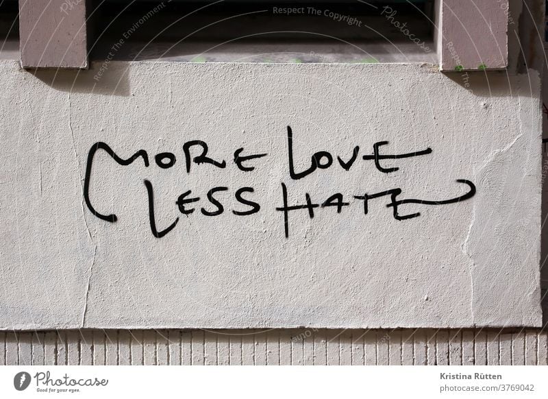 more love less hate written on a house wall Love no Hatred Graffiti street art slogan motto statement Remark saying next love togetherness Tolerant