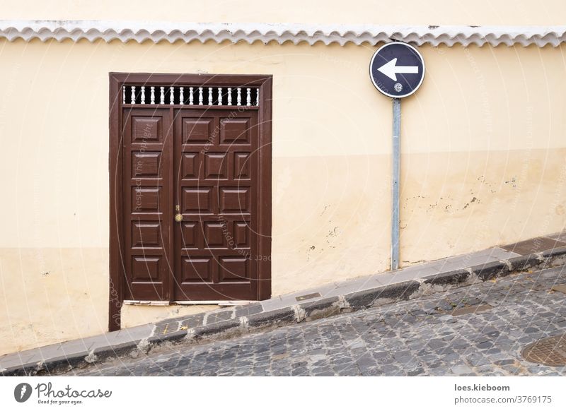 Steep street with wooden entrance door and left street sign, La Orotava, Tenerife, Canary Islands, Spain architecture canary old orotava one direction tenerife