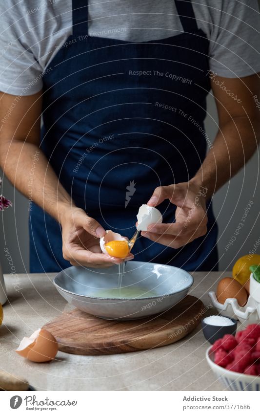 Cook breaking eggs over bowl cook food prepare kitchen culinary homemade yolk ingredient eggshell breakfast man meal chef raw cuisine dish recipe gastronomy