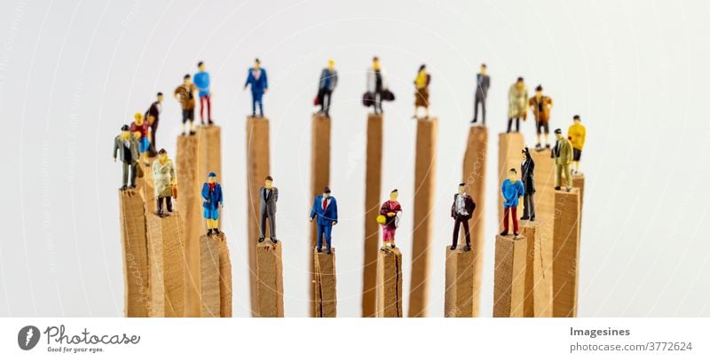 Social dissociation. A circle of miniature toy people on wooden poles keeping distance social problems Dissociation covid-19 Teamwork Concepts reduction