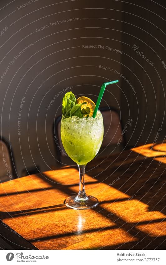 Green refreshing cocktail with mint green lemon glass drink alcohol cold ice bar straw beverage goblet refreshment cool pub citrus slush appetizing colorful