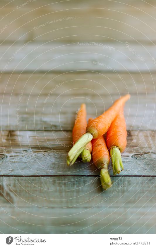 Group of baby carrots on defocused wooden background abstract agricultural bio carotene copyspace dietary food fresh freshness gastronomy harvest health healthy