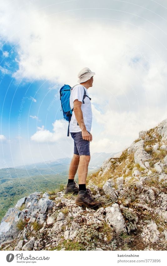 Men hiking in mountains in a sunny day men Sport nature outdoor acivity Recreation Trail Person Backpack Travel Challenge Effort Healthy Tourist Lifestyle