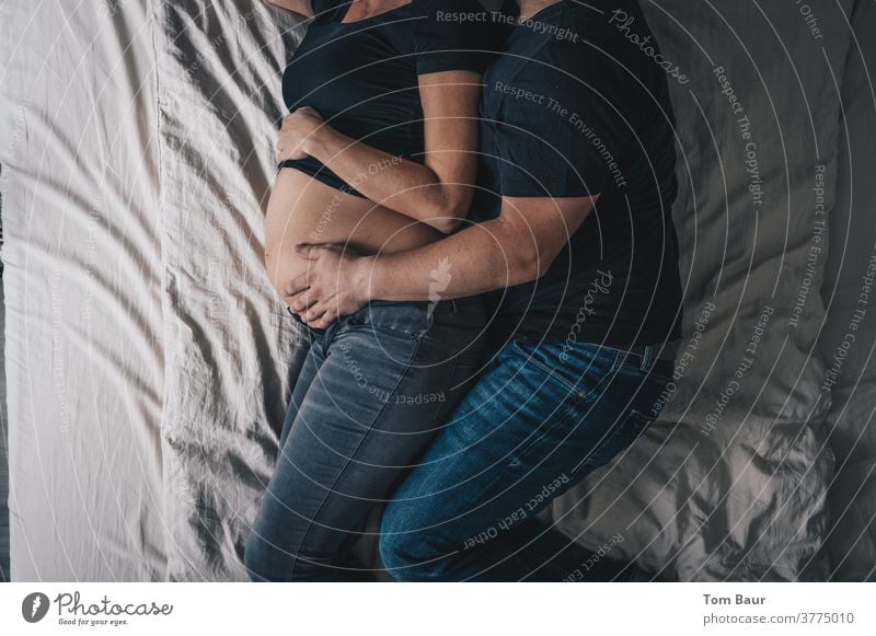 Lovers on the bed - He holds the stomach of his pregnant wife Pregnant pregnancy shooting Couple Woman Stomach Adults Baby bump Bathtub Mother Photo shoot