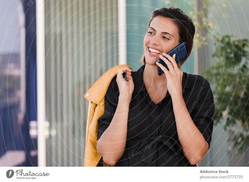 Pregnant woman talking on smartphone on the street pregnant sunny cellphone using pregnancy belly female cheerful speak call happy mobile positive expect smile