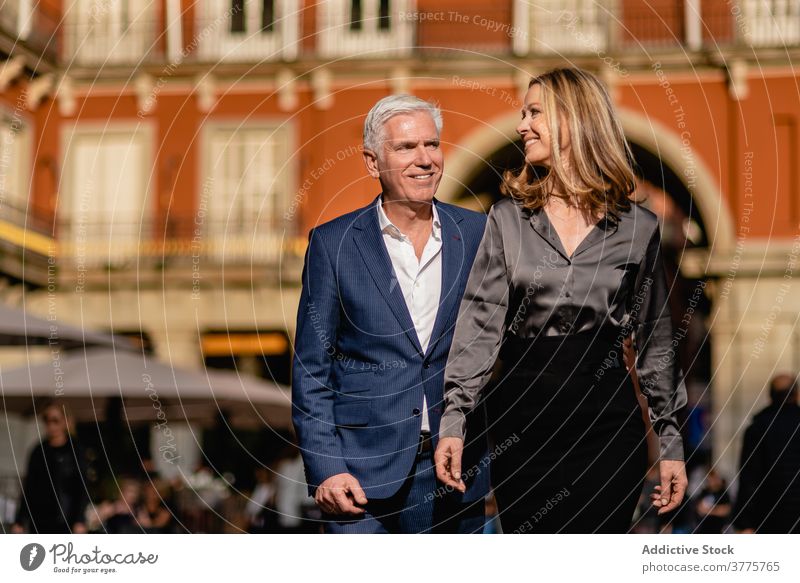 Cheerful mature couple in stylish outfits in city elegant style happy classy well dressed luxury rich cheerful fashion middle age together smile relationship