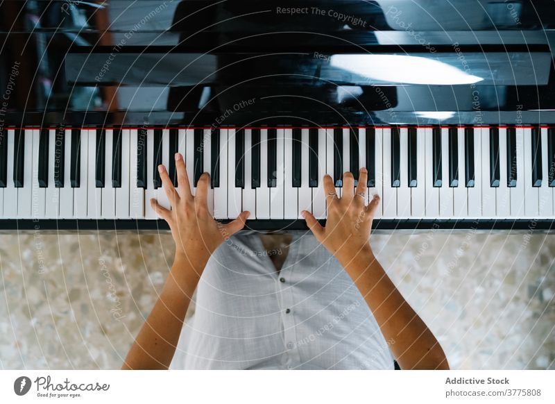 Crop woman playing piano at home musician sound melody rehearsal practice instrument female entertain apartment artist acoustic song hobby skill relax weekend