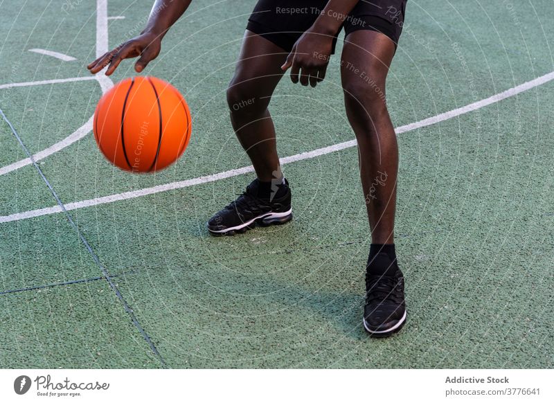 Concentrated black man playing basketball on court player sports ground playground tactic focus male african american ethnic modern professional healthy workout