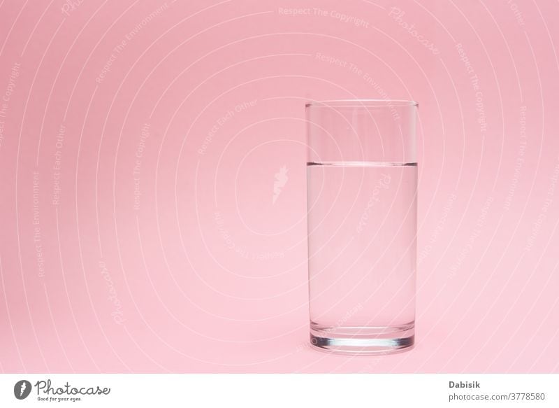 Glass of water on a pink background drink glass pure pour shadow concept liquid beverage clean healthy fresh freshness transparent white clear natural aqua
