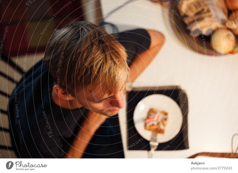Man Sitting Eating above view Above adult man eating fødselsdag birthday table Colour photo Shallow depth of field relaxed