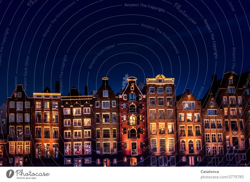 Art on building / Lighting concept Facade Architecture Manmade structures Building houses row of houses Town dwell Apartments at night Old Dark colored Blue