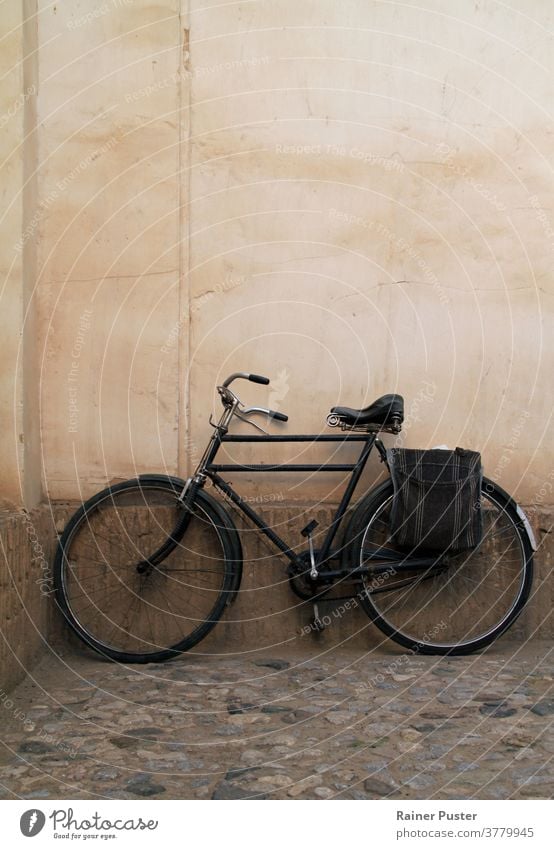 Vintage bike leaning against a wall antique background bicycle classic old outdoor retro road street style town transport transportation urban vintage wheel