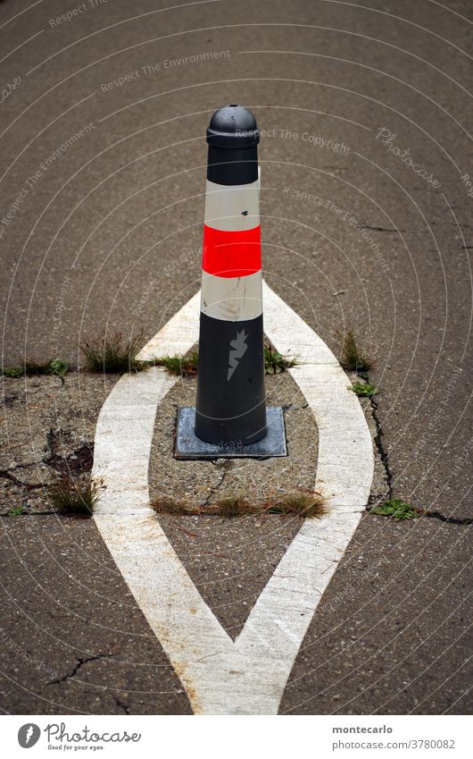 Bollard on a bicycle path with extra markings Asphalt gap bicycle lane Risk of accident accident cover Traffic regulation traffic control Street trace Transport