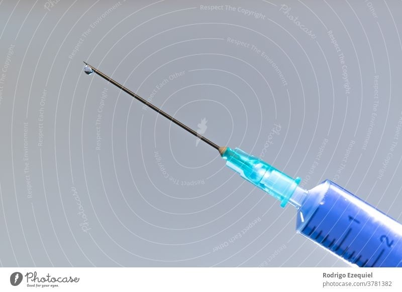Close-up of a Medical Syringe With A Vaccine background blue care clinic closeup coronavirus covid-19 doctor dose drug equipment flu health health care hospital