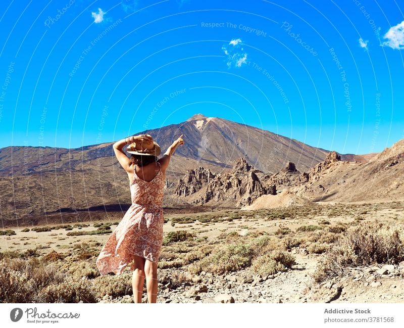 Traveling woman in dress in highland area travel summer mountain carefree tourism valley holiday female tenerife spain mount teide canary islands nature tourist