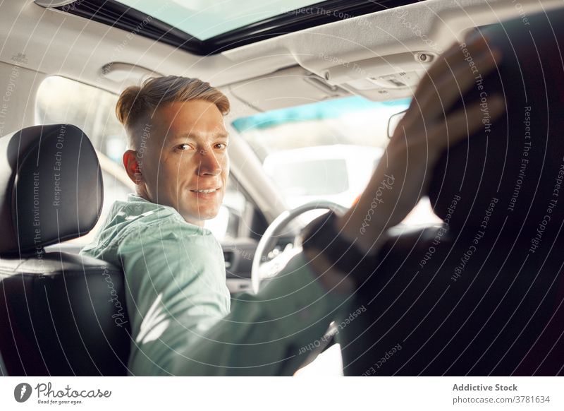 Stylish man on driver seat in car interior auto automobile smile handsome luxury male style trendy transport vehicle automotive masculine delight parked modern