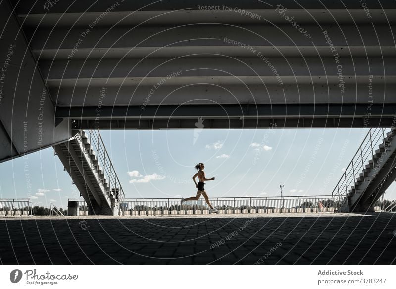 Active woman running on street sportswoman runner training fit athlete workout fitness active wellness silhouette cardio marathon motion power sprint speed