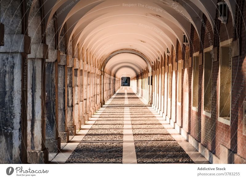 Arched passage with stone columns in city arched gallery archway walkway architecture aged sunlight historic exterior building amazing old facade ancient