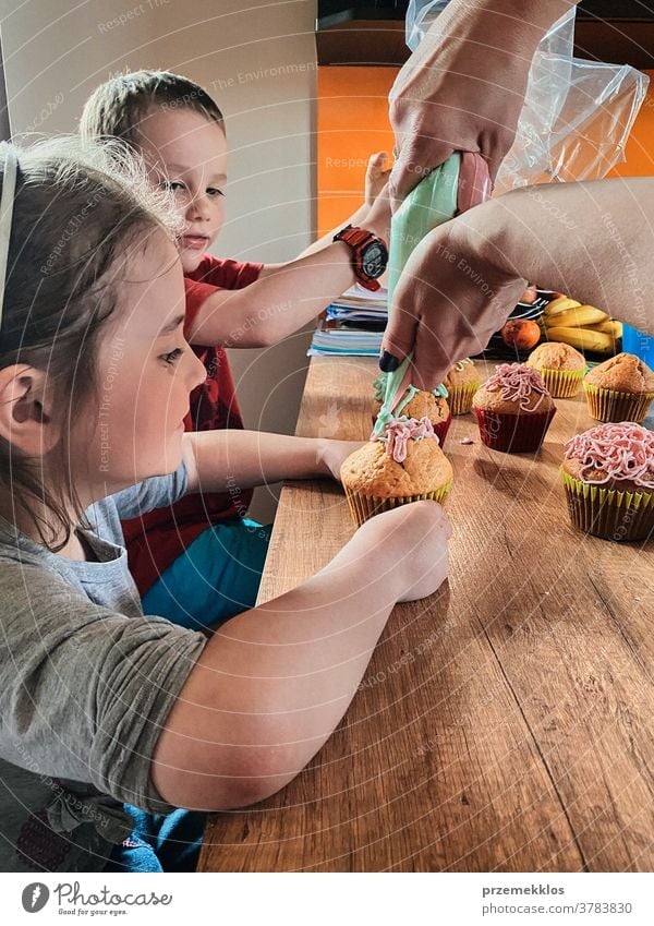 Children baking cupcakes, preparing ingredients, decorating cookies children cooking bake family domestic muffin together childhood happy little kid kitchen