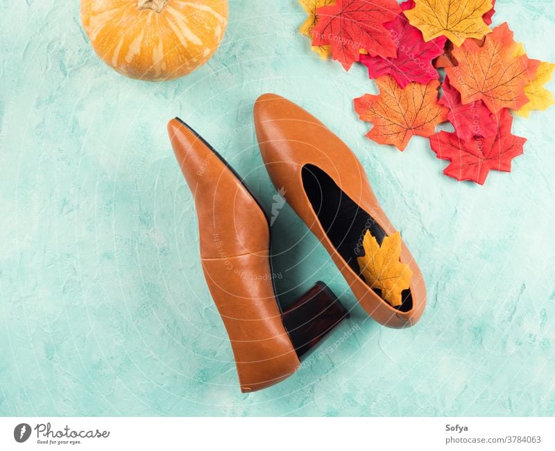 Female trendy fall color shoes with leaves autumn fashion october walk female background pump leather pumpkin seasonal symbols turquoise flat lay yellow orange