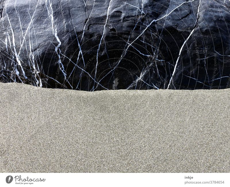 Lined stone in fine sand Colour photo Stone Sand Fine Heavy black somber Contrast lines structure Pattern half Copy Space Deserted Close-up White sand-coloured