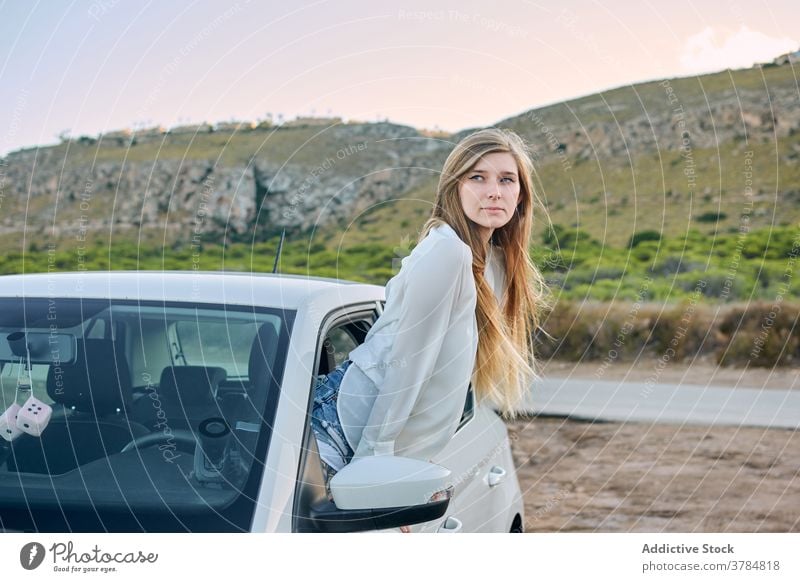 Delighted female traveler out of car window woman enjoy carefree wanderlust automobile summer nature vacation evening rest adventure happy relax driver trip