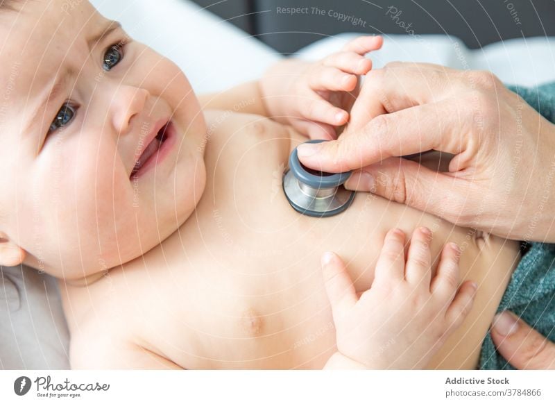 Baby at the pediatrician in a medical examination baby body boy care child clinic cute doctor examining hand happy health healthcare healthy heartbeat hospital