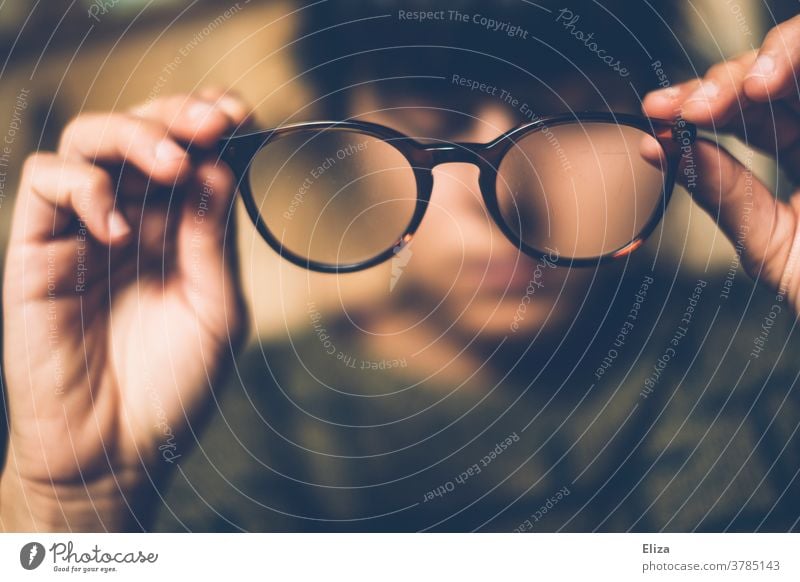 A woman takes off her glasses Eyeglasses Vista Observe look at decrease Woman Person wearing glasses blurred Vision visually impaired