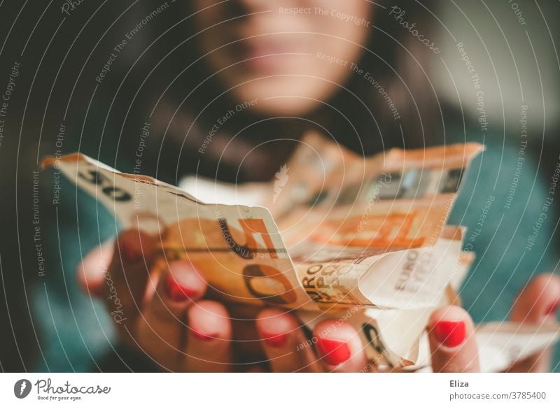 A woman holds a lot of money in her hand. Success. Returns. Profit. Money Luxury profit Bank note Many Joy Loose change Euro Financial Industry bonanza Laughter