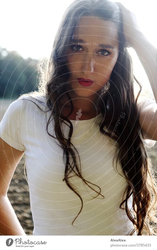 Backlit portrait of a young woman Woman pretty Near fit daintily Skin Face look Direct Long-haired Slim Athletic youthful 18 - 30 years Adults Summer Warmth