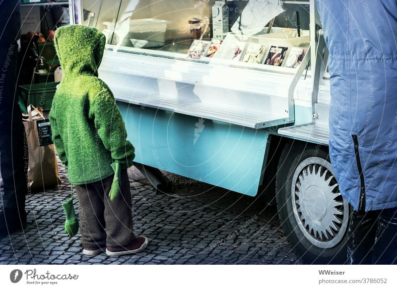 Winter dressed child languishes the offer of the ice cream van Child Cardigan Hooded (clothing) mittens Gloves Showcase Display Ice ice car sales booth