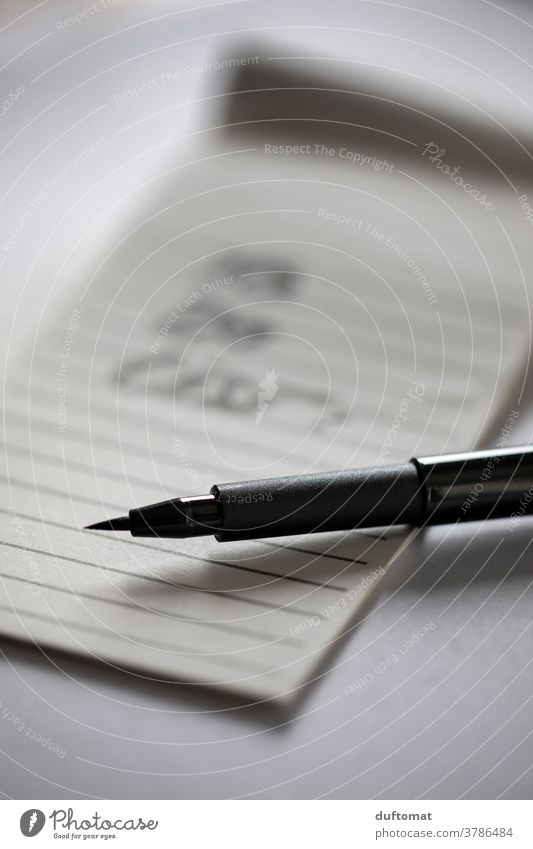 Black pen lies on lined piece of paper Piece of paper memo Paper Write Stationery Pen Interior shot Education Workplace School Office Office work