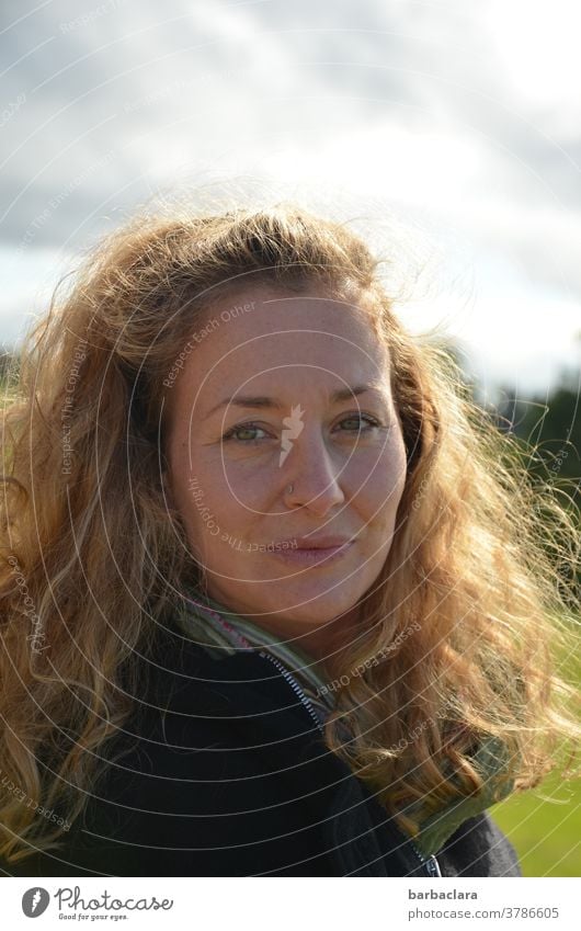 windswept Woman Wind Autumn windy Blown away Mop of curls Curl Nature green eyes Clouds
