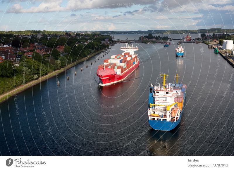 Container ships and cargo vessels at the lock from the Kiel Canal to the Kiel Fjord. View from the bridge over the canal towards the Baltic Sea Keel cargo ship