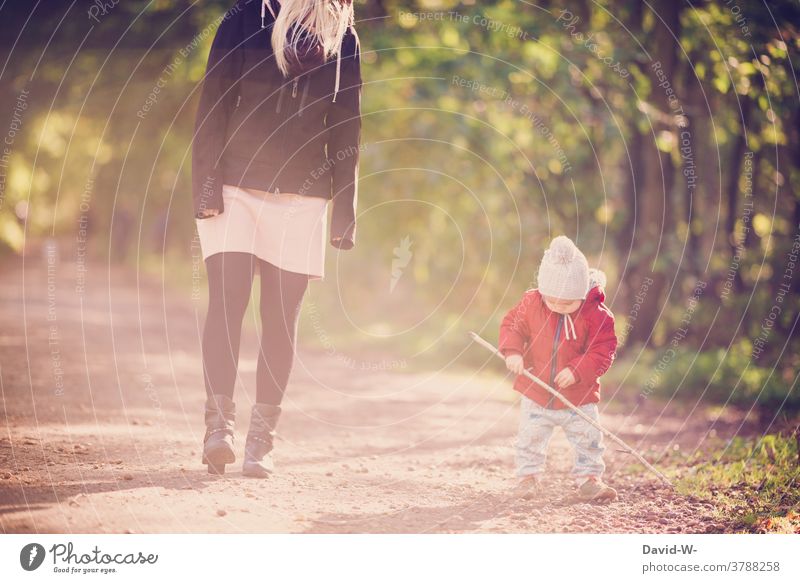 Mother and child taking an autumnal walk Family Child mama Son To go for a walk Forest Autumnal at the same time Love in common Playing Stick Parents Toddler