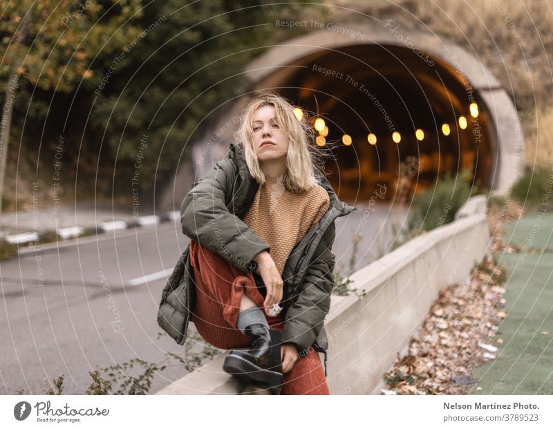 Portrait of a blonde woman autumn, with a tunnel in the background. leaves urban portrait caucasian fashion Exterior shot Fashion Caucasian Lifestyle Street