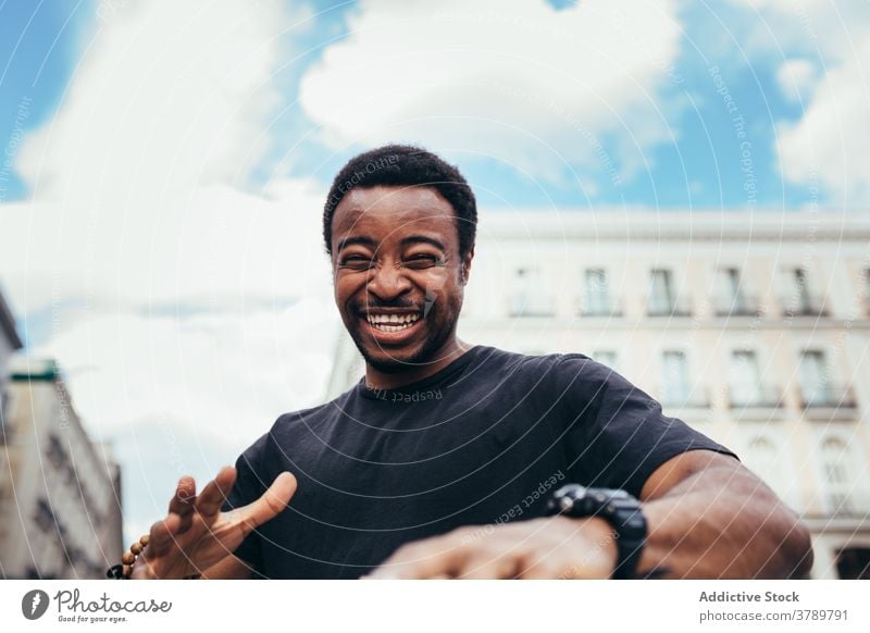 Happy black man posing on city environment happy portrait african people american male person guy adult expression background one laughing confidence face cool