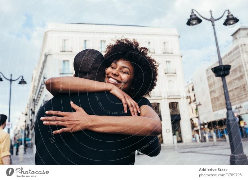 Happy african american couple hugging city love people relationship embracing happiness young happy woman two boyfriend romance together outdoors romantic