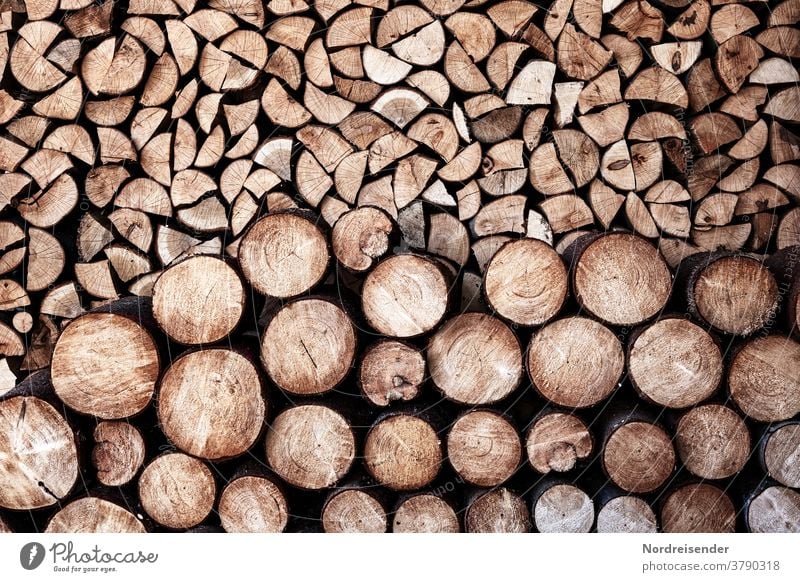 Stacking and storage of firewood Wood background Firewood Stack of wood self-sufficient Sustainability Energy Heat heating costs fuel Material structure texture