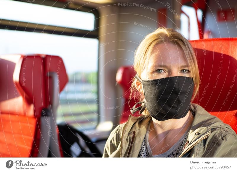 Woman travelling in a railway train wearing a self made face mask. Coronavirus and travel concept subway corona coronavirus woman person public protect sick