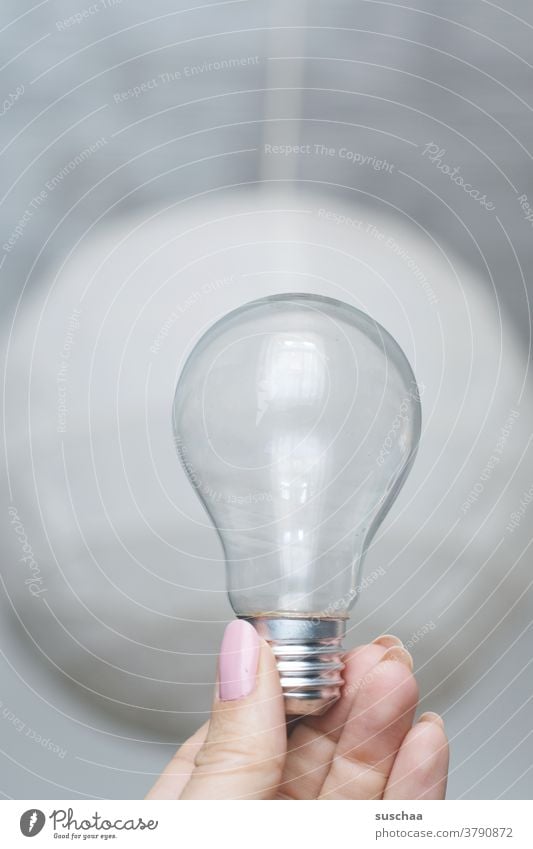 empty light bulb, held by a female hand Electric bulb Glass Empty Hand Fingers fingernails feminine Screw top Pear pear-shaped Transparent Archaic To hold on