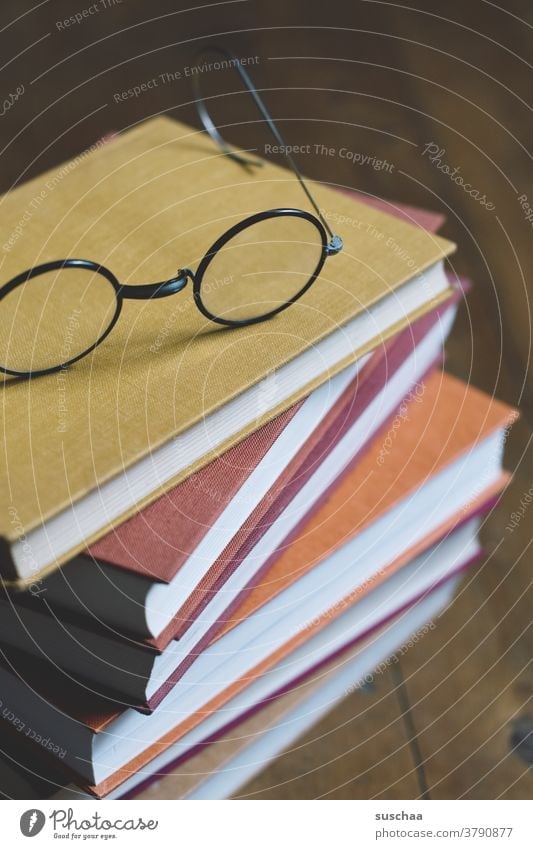 stack of books with glasses on top Book pile of books Eyeglasses tranquillity relaxation Reading Time Autumn Winter cold season autumn colours time change
