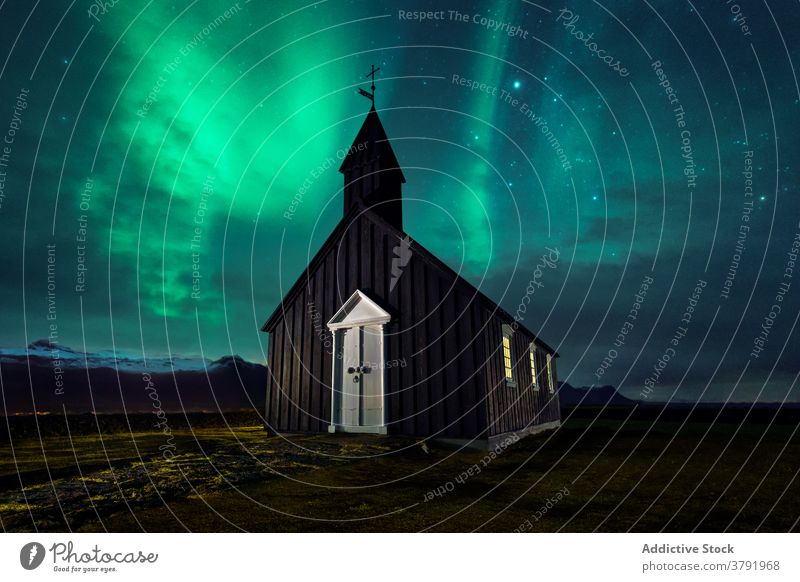 Small church at night against sky with aurora borealis phenomenon building northern light star iceland scenery scenic meadow wooden nature landscape magnificent